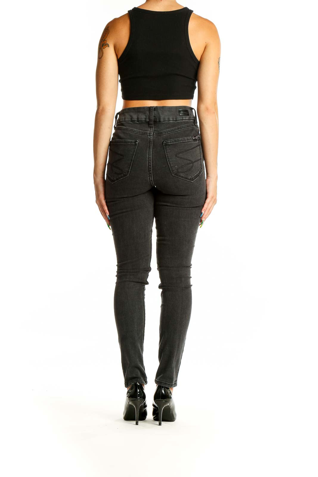 Back view of Seven7 black distressed skinny jeans on model