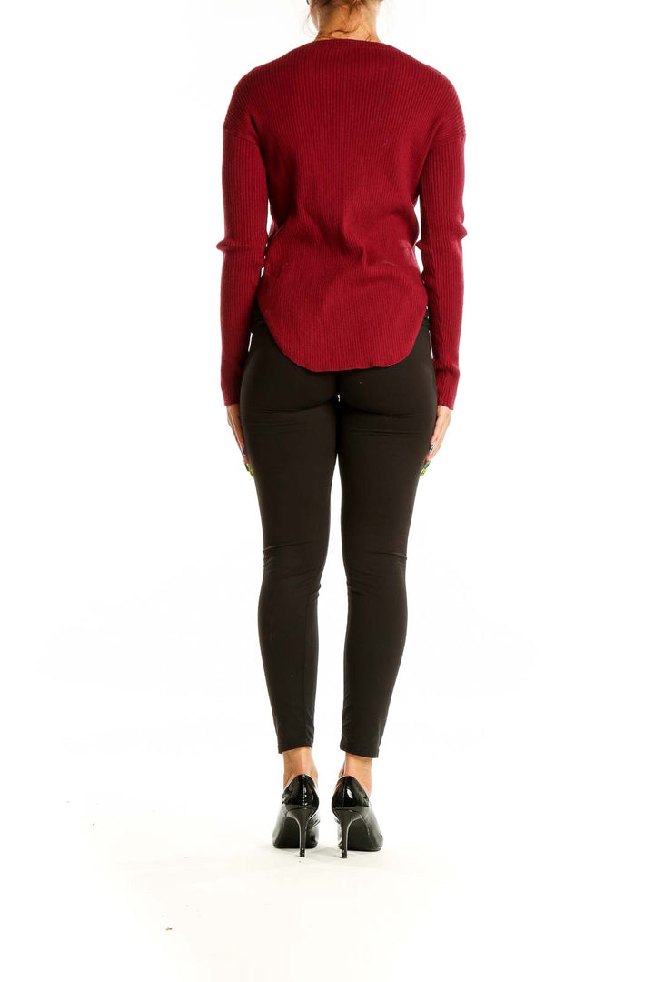 Back view of red ribbed knit sweater from Express showing curved hemline