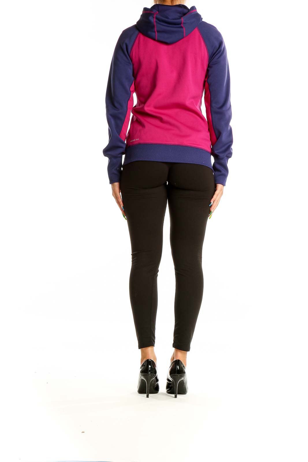 Back view of pink and navy Nike colorblock hooded sweatshirt on model