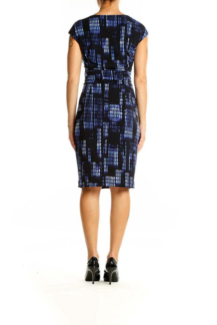 Back view of Calvin Klein blue and black abstract print sheath dress showing fitted silhouette