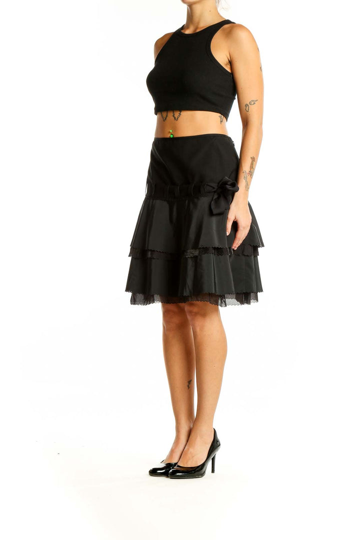 Front view of Elie Tahari black tiered ruffle skirt with bow-detailed waistband