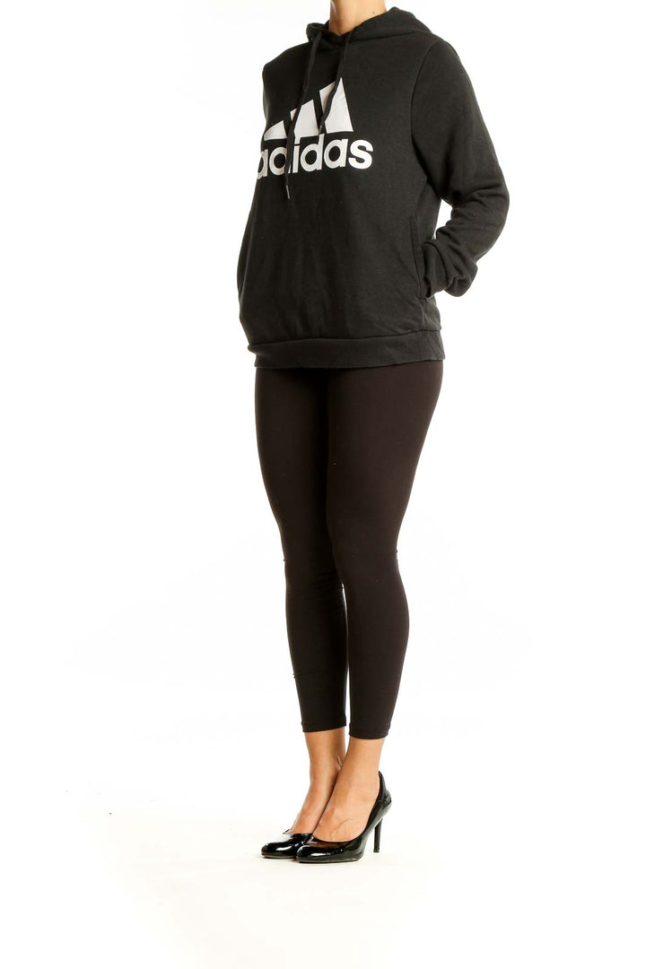 Front view of black Adidas performance hoodie with white logo