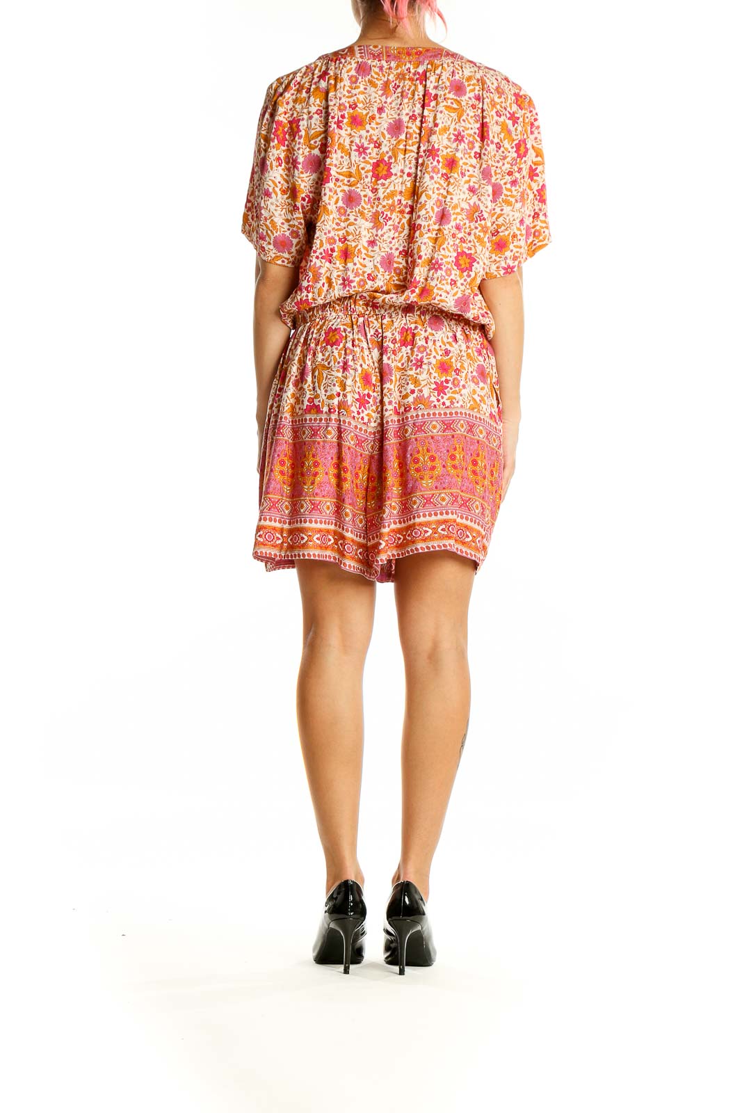 Back view of Lucca pink floral rayon romper showing relaxed fit and border print