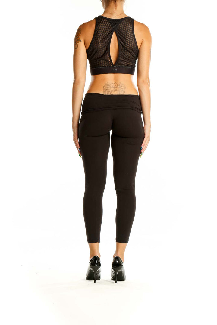 Back view of Lululemon x Peloton Black Crop Top with mesh panel and keyhole cutout