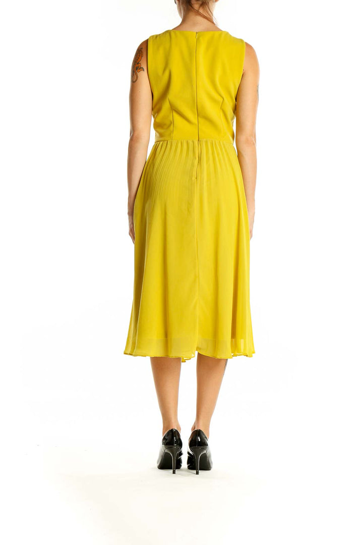 Back view of Shelby & Palmer yellow sleeveless midi dress showing zipper closure