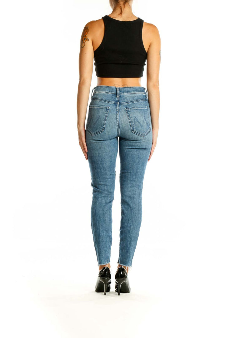 Back view of Mother blue high-rise skinny jeans showing pocket design