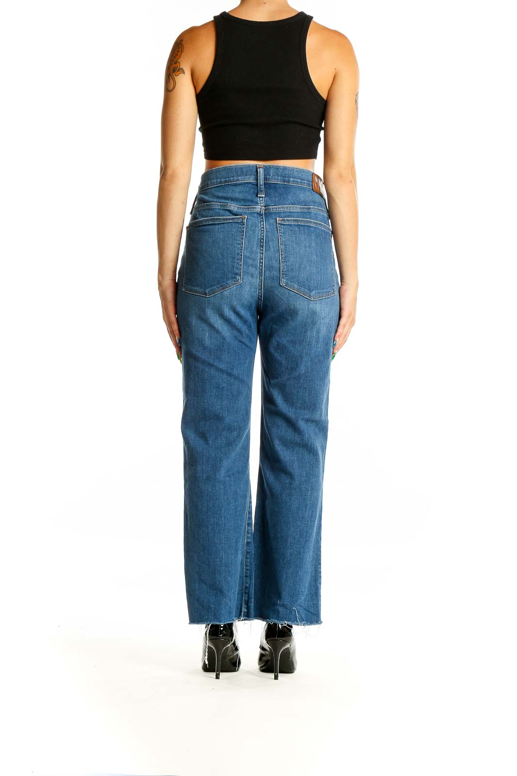 Back view of Madewell blue high-waisted wide-leg jeans showing raw hem