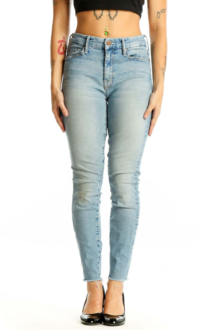 Front view of Mother light blue skinny jeans with raw hem