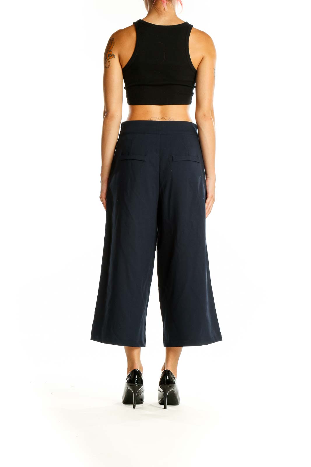 Back view of Unique Vintage navy wide-leg cropped trousers on model