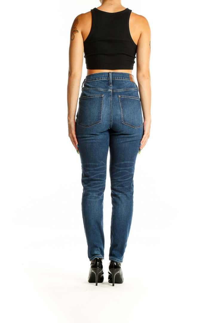 Back view of Madewell blue high-rise straight-leg jeans on model