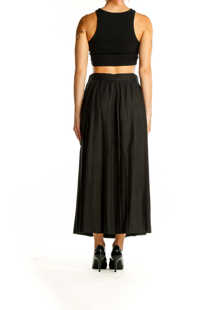 Back view of Pearl C black pleated silk midi skirt on model