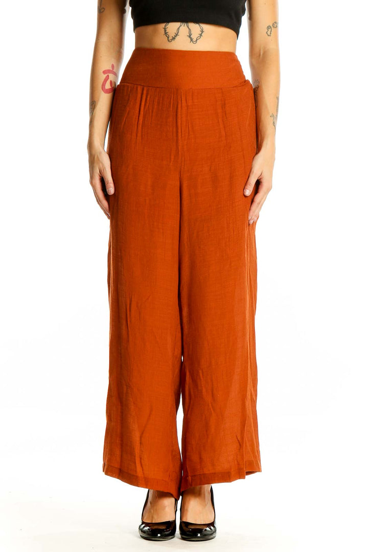 Front view of Nanette Lepore rust-colored wide-leg palazzo pants