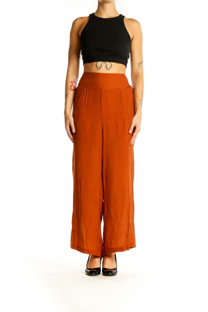 Front view of Nanette Lepore rust-colored wide-leg palazzo pants