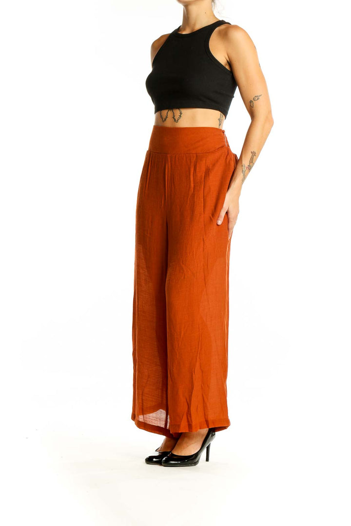 Front view of Nanette Lepore rust-colored wide-leg palazzo pants