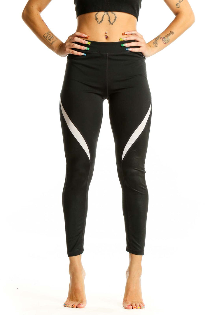 Front view of black GapFit high-waisted leggings with white side panels