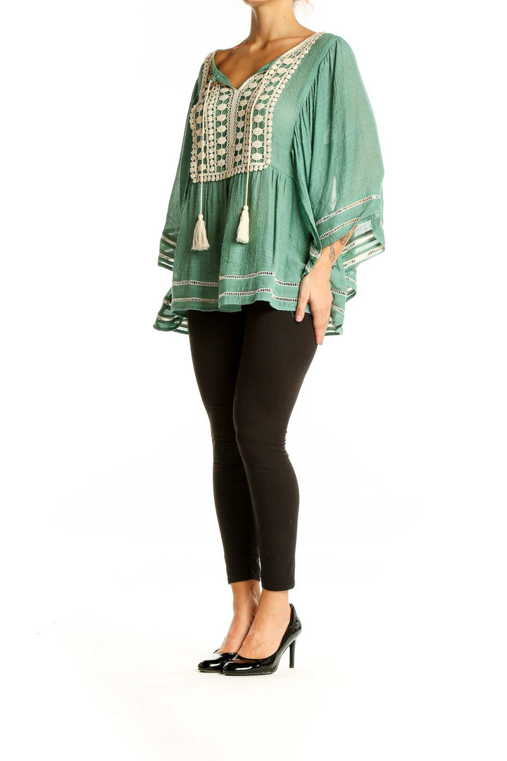 Front view of Entro sage green blouse with crochet trim and bell sleeves