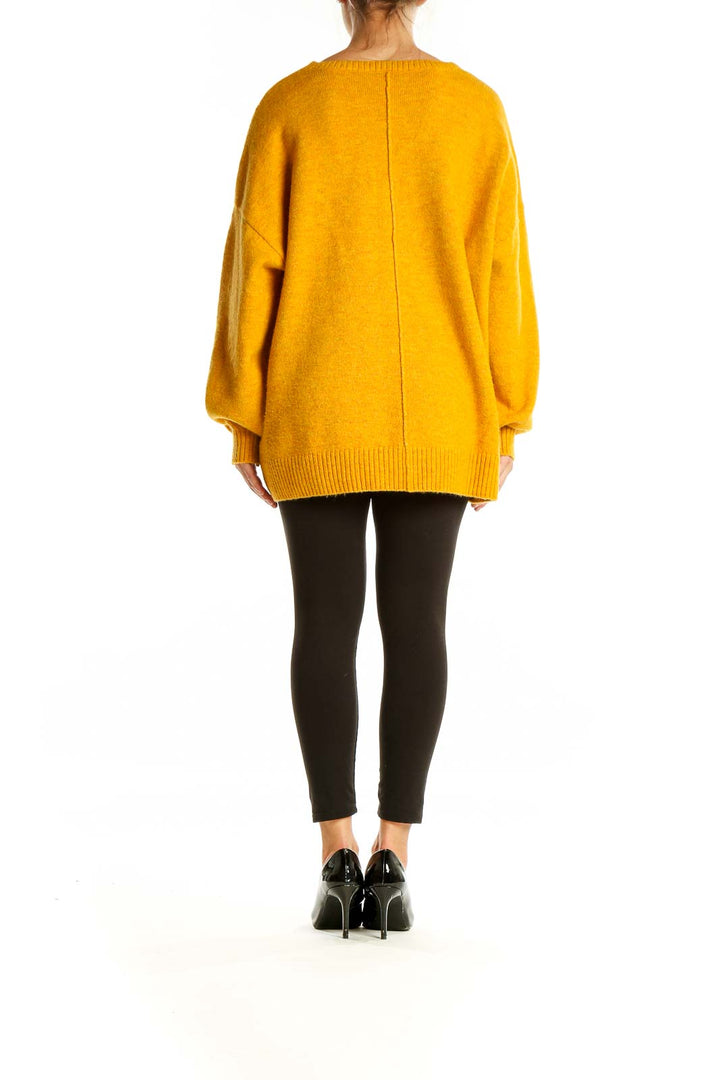 Back view of Vince Camuto yellow oversized knit sweater showing relaxed fit