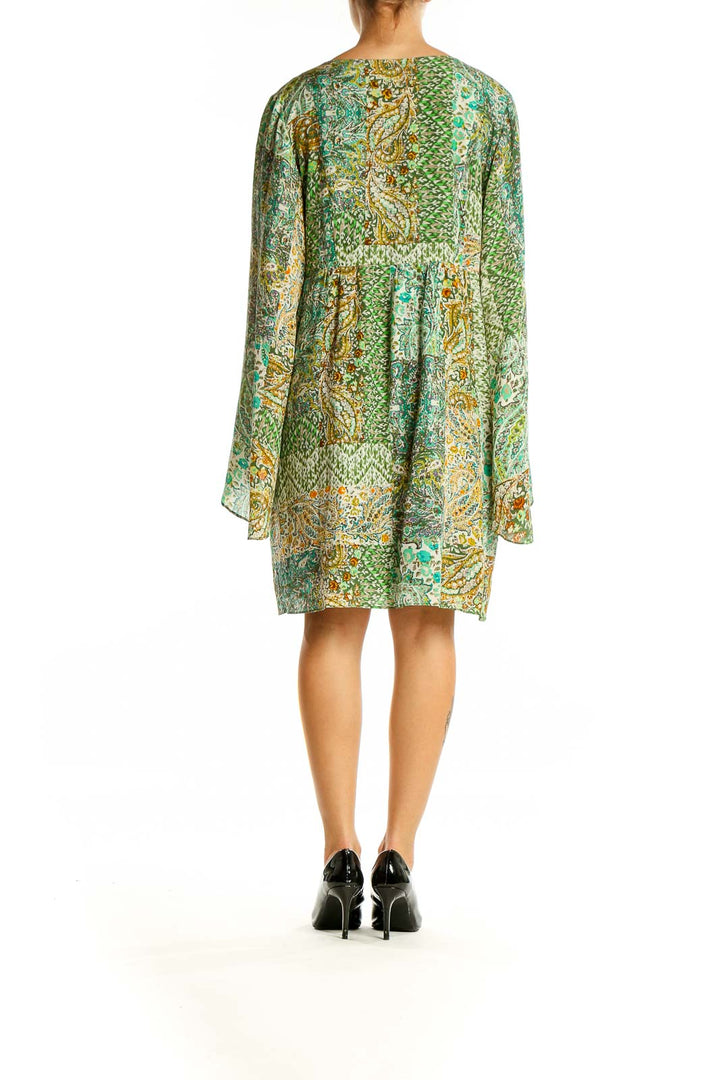 Back view of green paisley silk tunic dress showing flowing silhouette