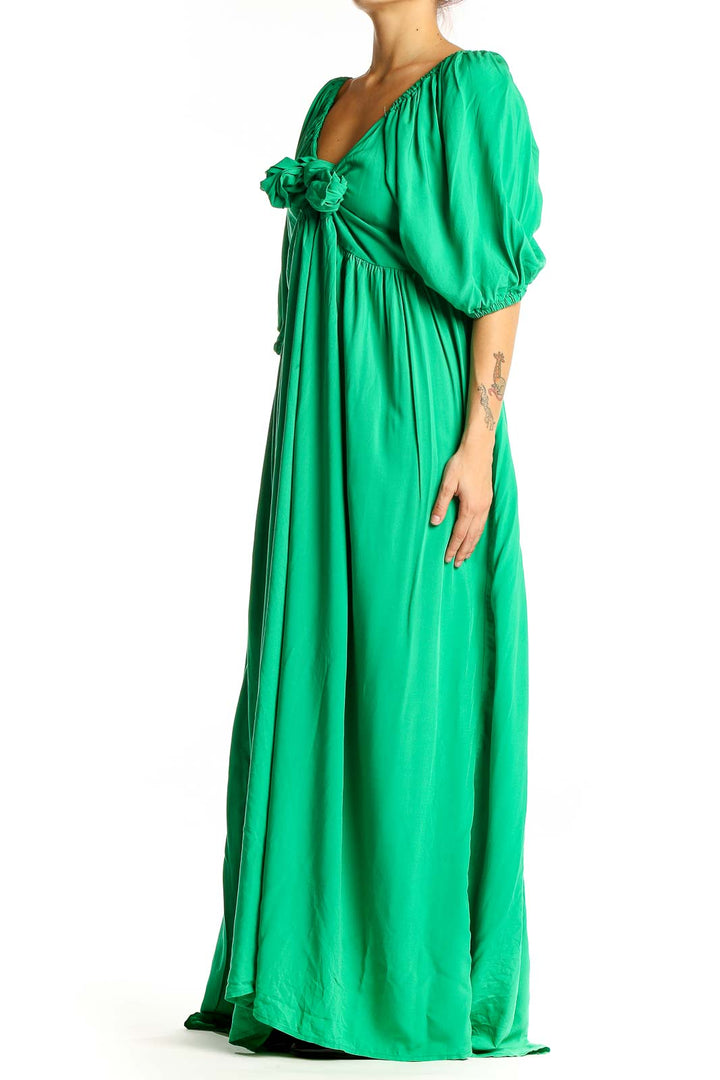 Front view of Eloquii green rayon maxi dress with V-neck and bow detail