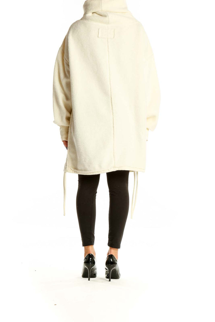 Back view of cream oversized fleece turtleneck jacket from WE THE FREE