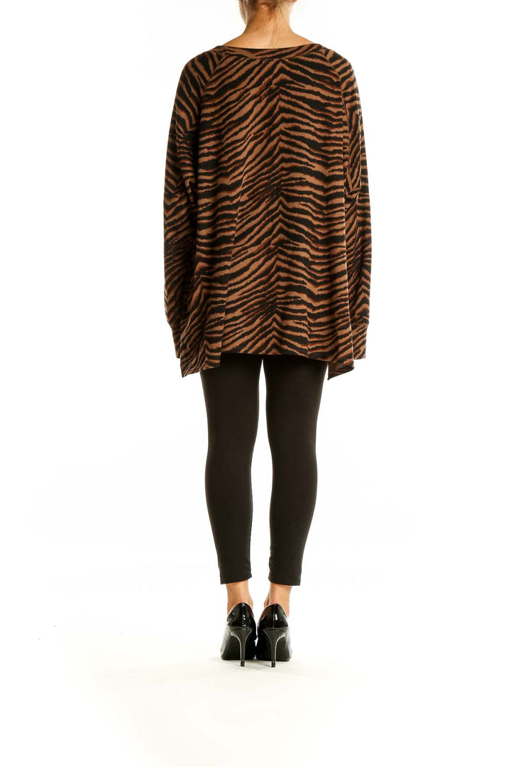 Back view of Sanctuary brown tiger stripe oversized knit sweater on model