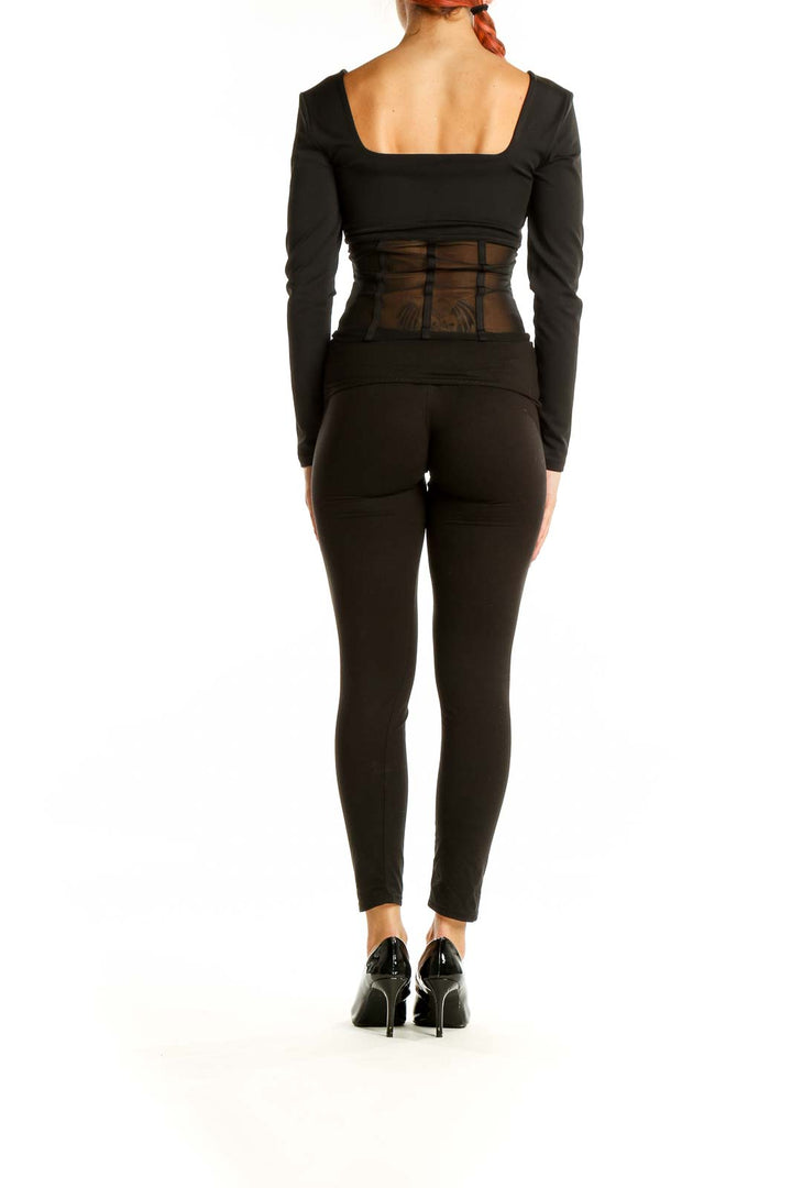 Back view of black Express long sleeve top showing sheer mesh panel detail