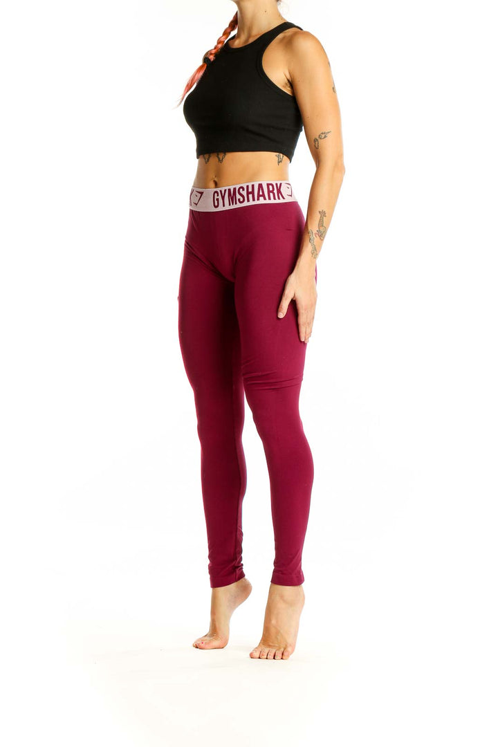 Front view of Gymshark burgundy high-waisted compression leggings