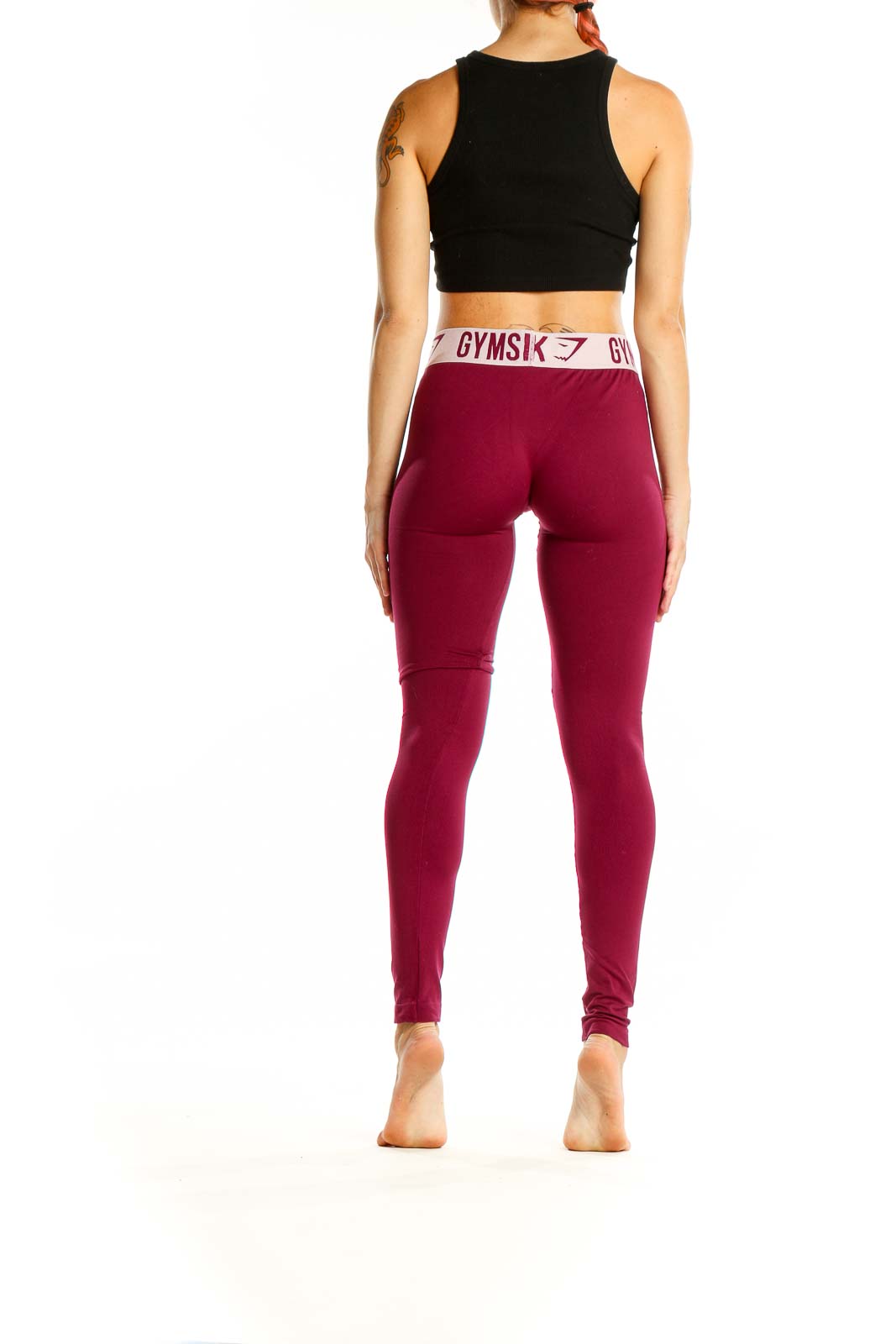 Back view of Gymshark burgundy high-waisted compression leggings with black crop top