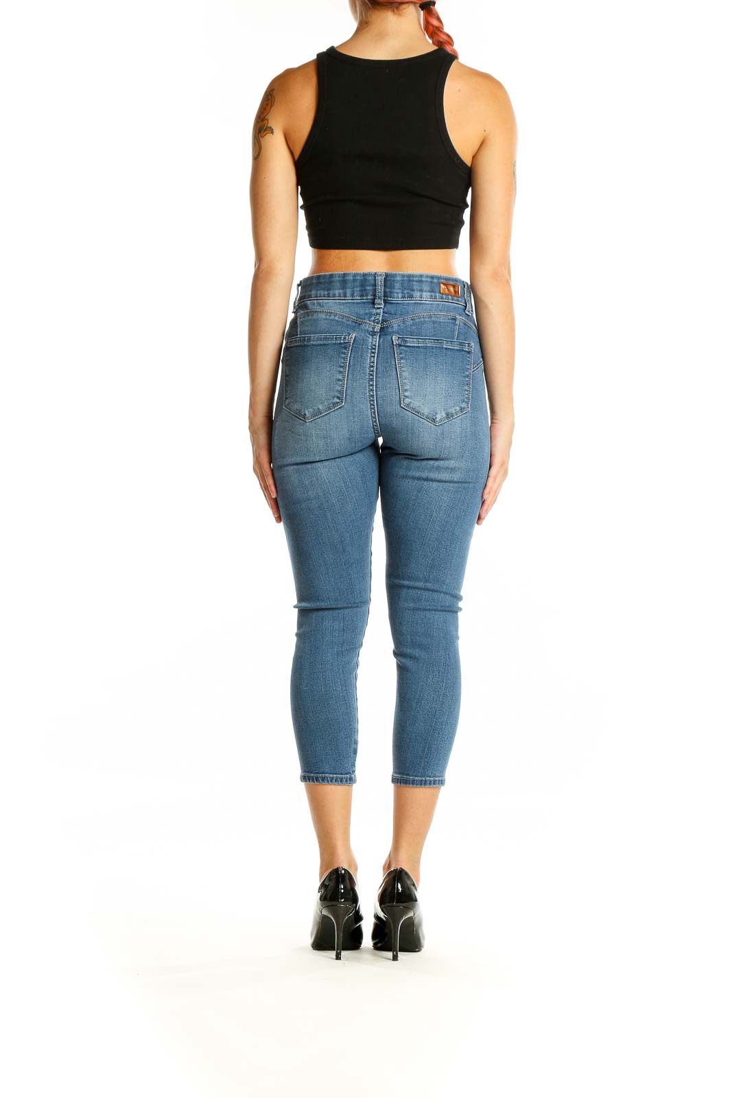 Back view of Juicy Couture blue cropped skinny jeans on model