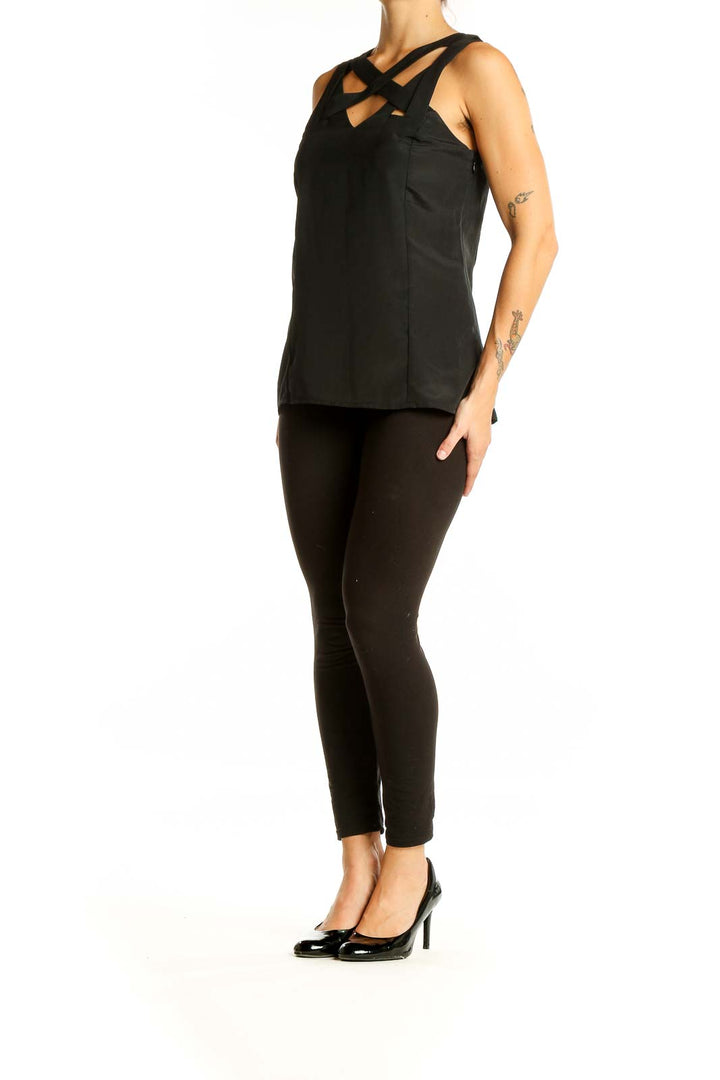 Front view of black sleeveless top with strappy neckline design