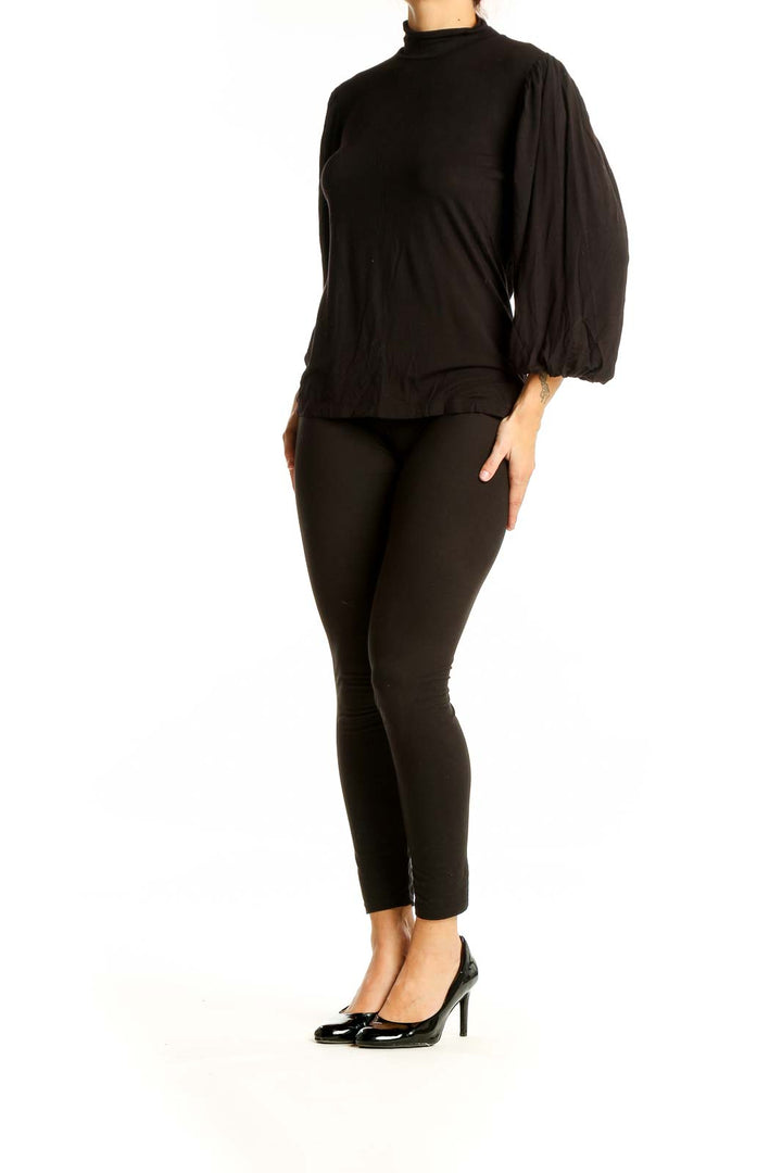 Front view of black Premise mock neck top with billowy sleeves