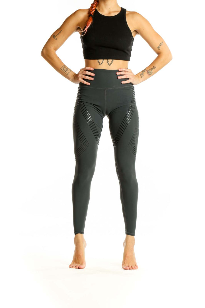 Front view of Alo dark green high-waisted performance leggings with chevron pattern