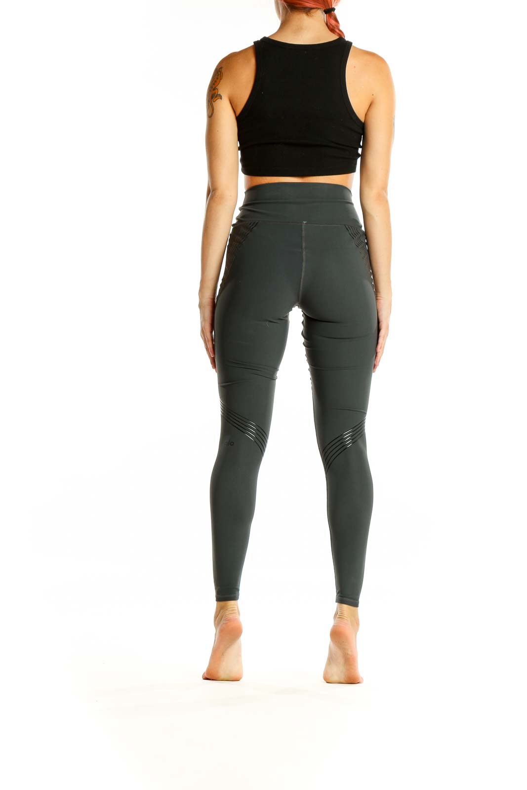 Back view of Alo dark green high-waisted performance leggings on model