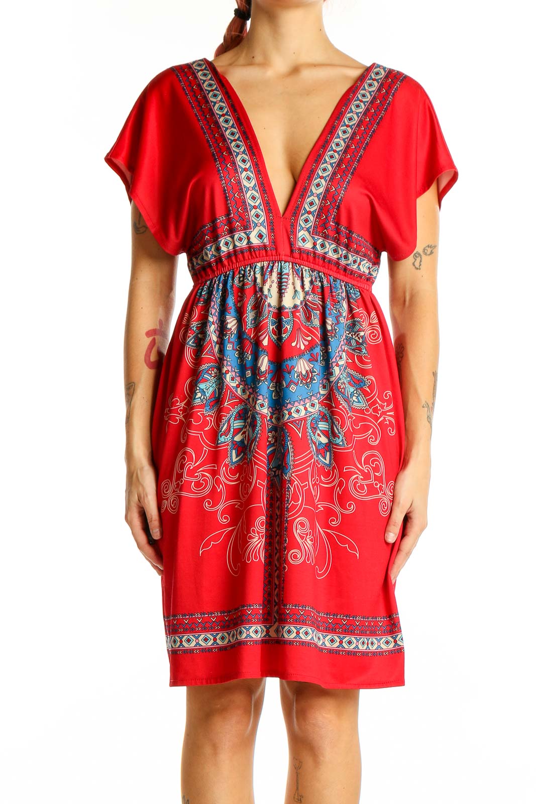 Front view of red bohemian mini dress with embroidered V-neckline and empire waist