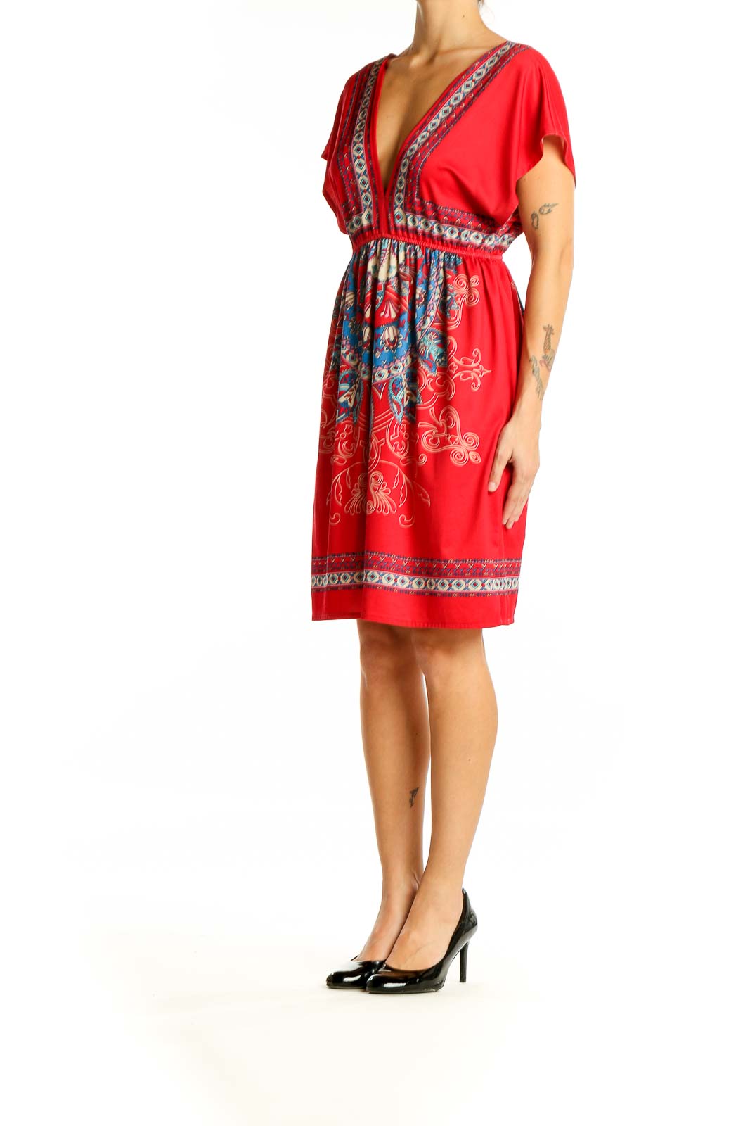 Front view of red bohemian mini dress with embroidered V-neckline and empire waist