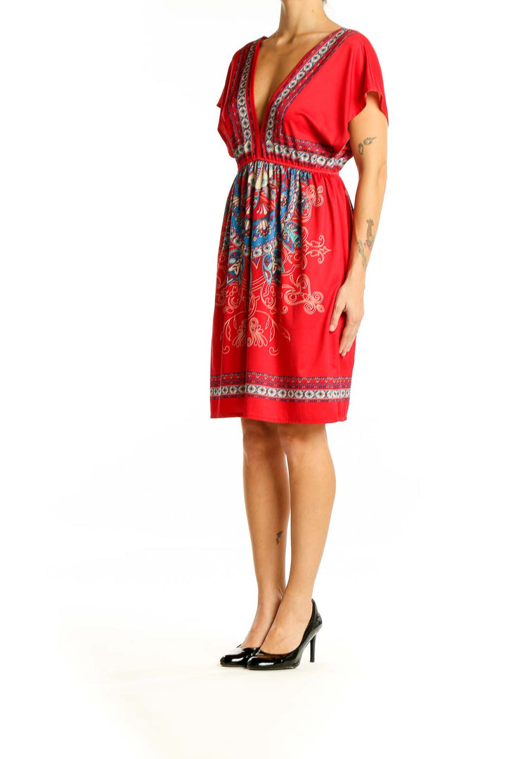 Front view of red bohemian mini dress with embroidered V-neckline and empire waist