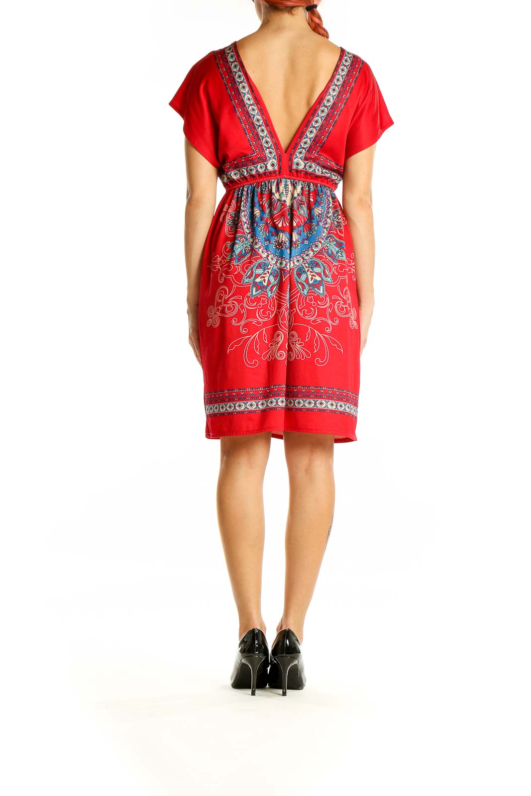 Back view of red bohemian mini dress showing V-back and embroidered hem detail