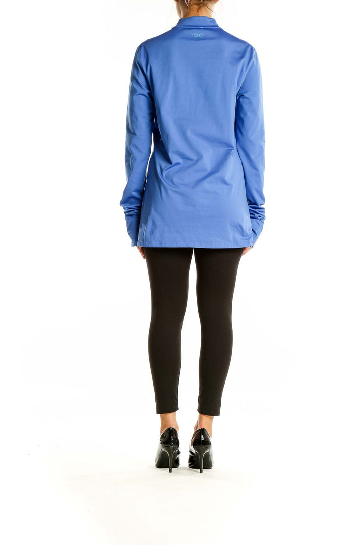 Back view of blue Under Armour quarter-zip athletic top on model