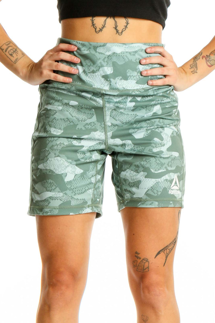 Front view of green camouflage Reebok high-waisted athletic shorts