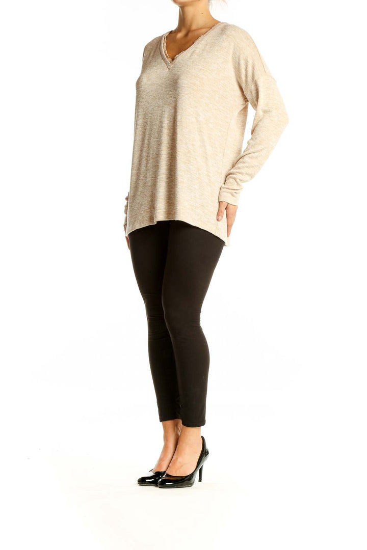 Front view of Doe & Rae beige V-neck sweater with lace trim