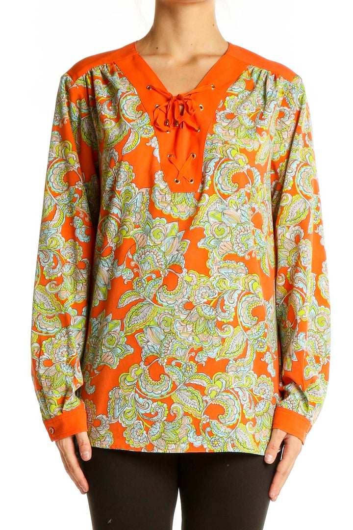 Front view of Jones New York orange floral lace-up blouse with paisley print