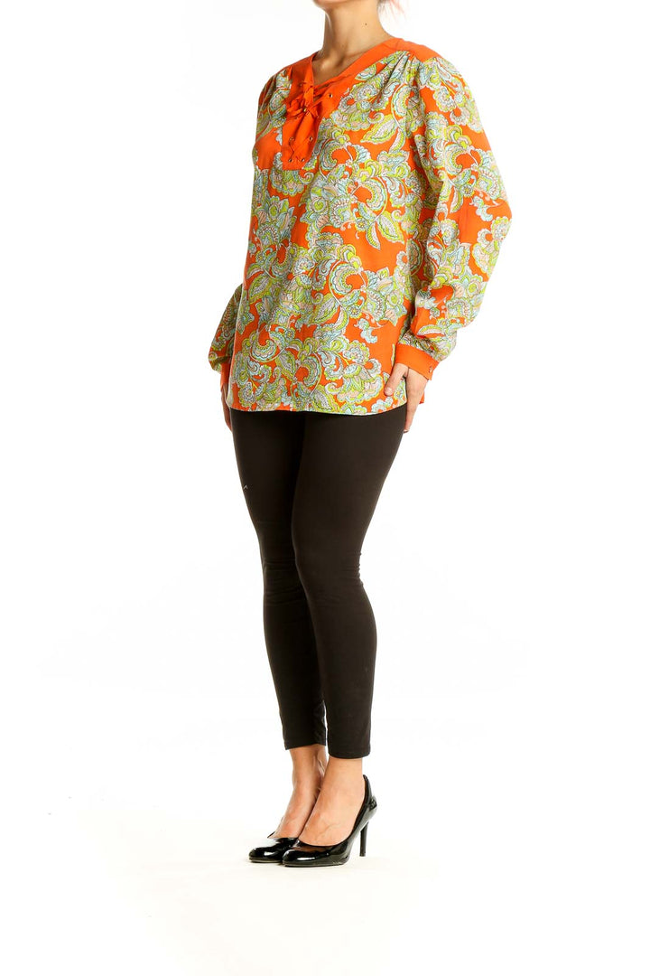 Front view of Jones New York orange floral lace-up blouse with paisley print