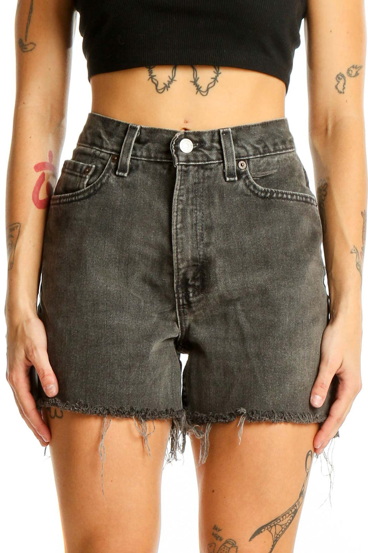 Front view of gray distressed Levi's denim shorts with frayed hem