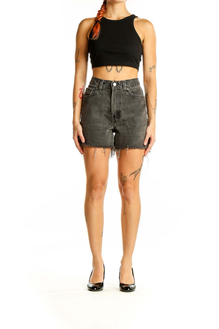 Front view of gray distressed Levi's denim shorts with frayed hem