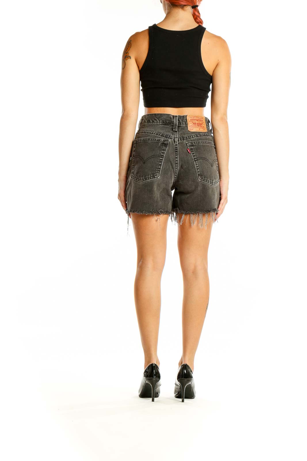 Back view of gray distressed Levi's denim shorts showing pocket design