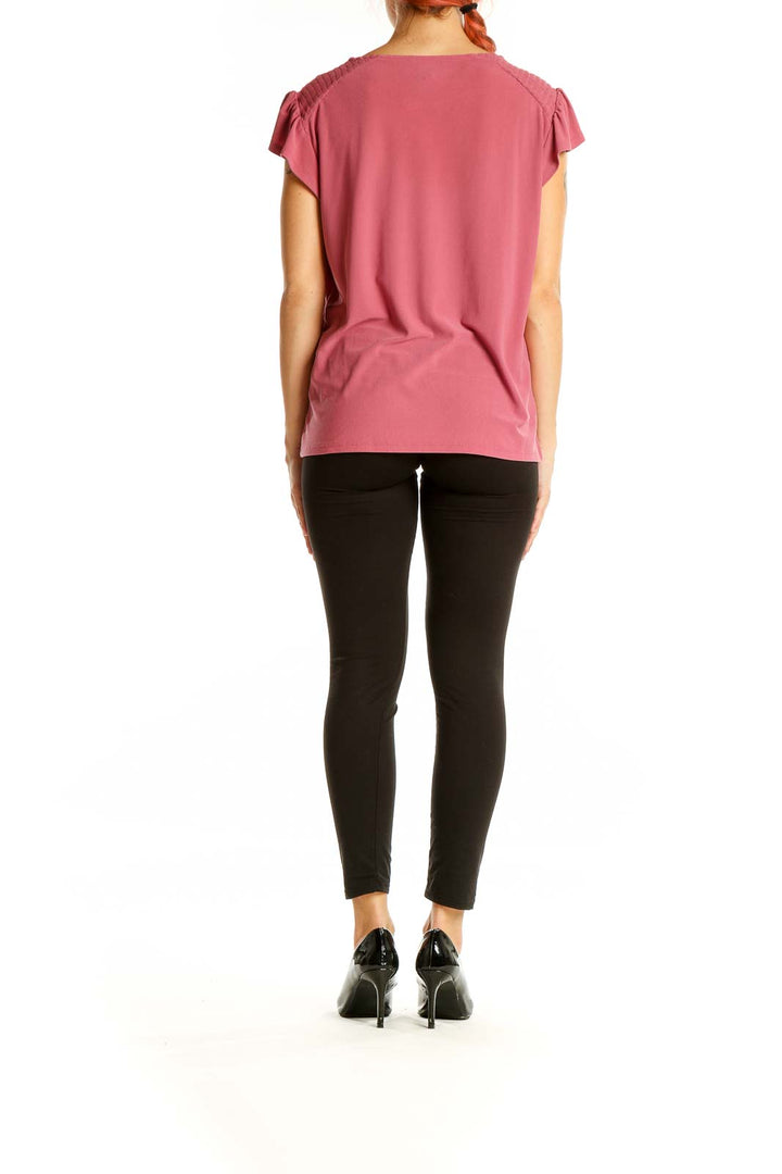 Back view of pink CeCe blouse showing relaxed fit