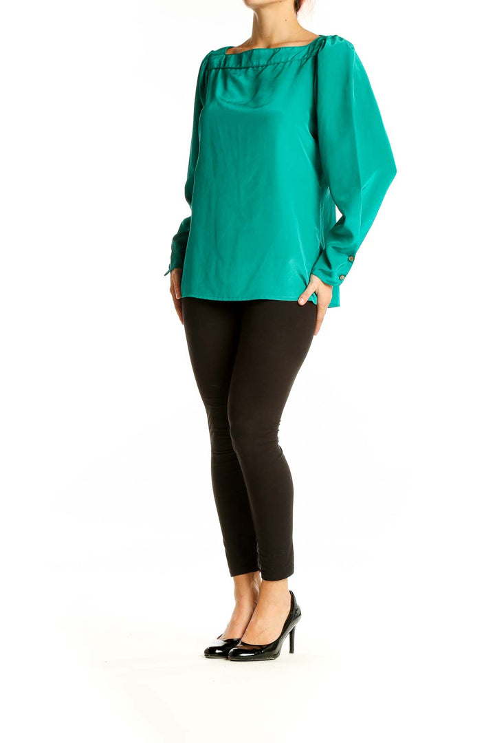 Front view of emerald green Regina Porter long-sleeve blouse with boat neckline