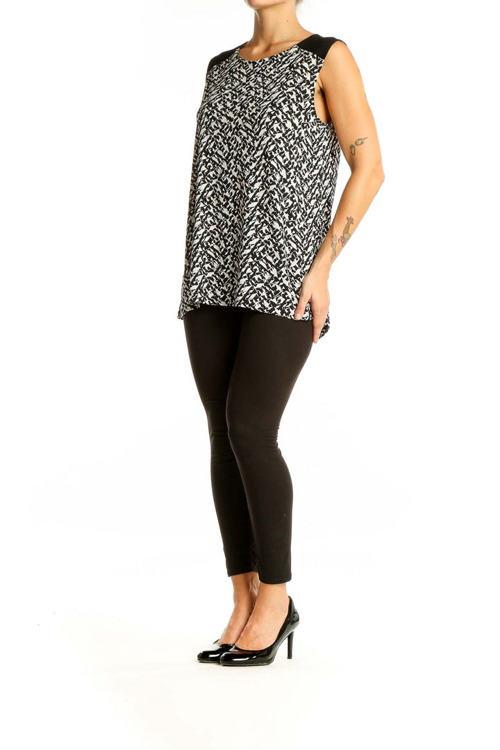 Front view of Vince Camuto black and white abstract print sleeveless top