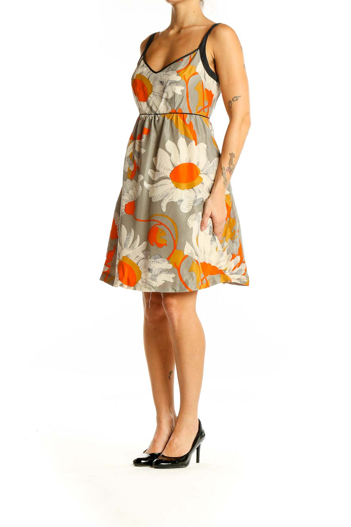 Front view of Moulinette Soeurs gray floral print sleeveless sundress with orange accents