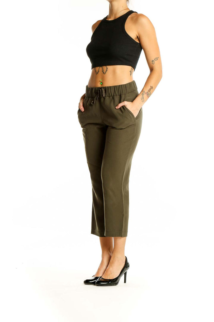 Front view of olive green Lululemon cropped activewear pants with elastic waistband